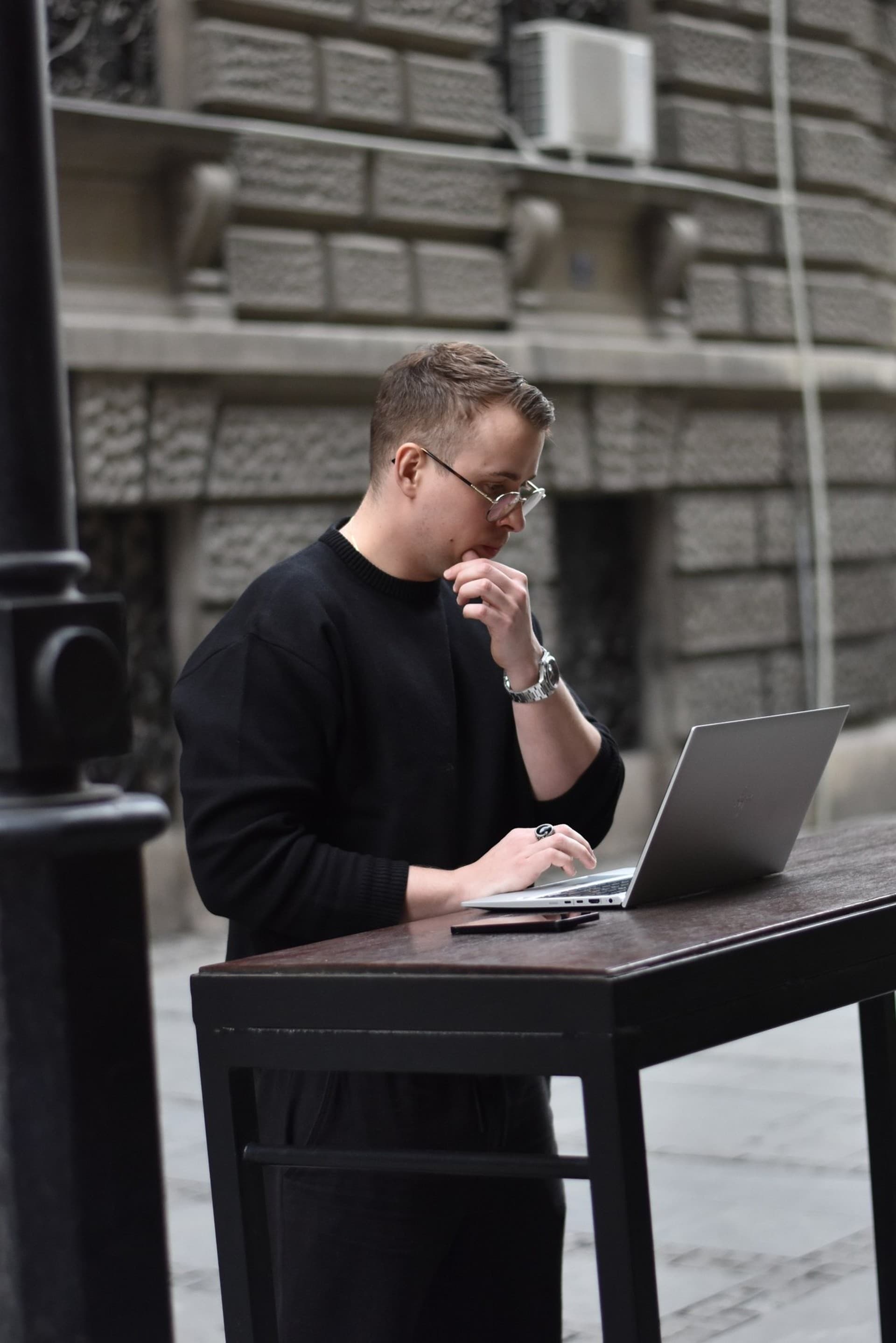 Christopher Krassnig working on a laptop outdoors