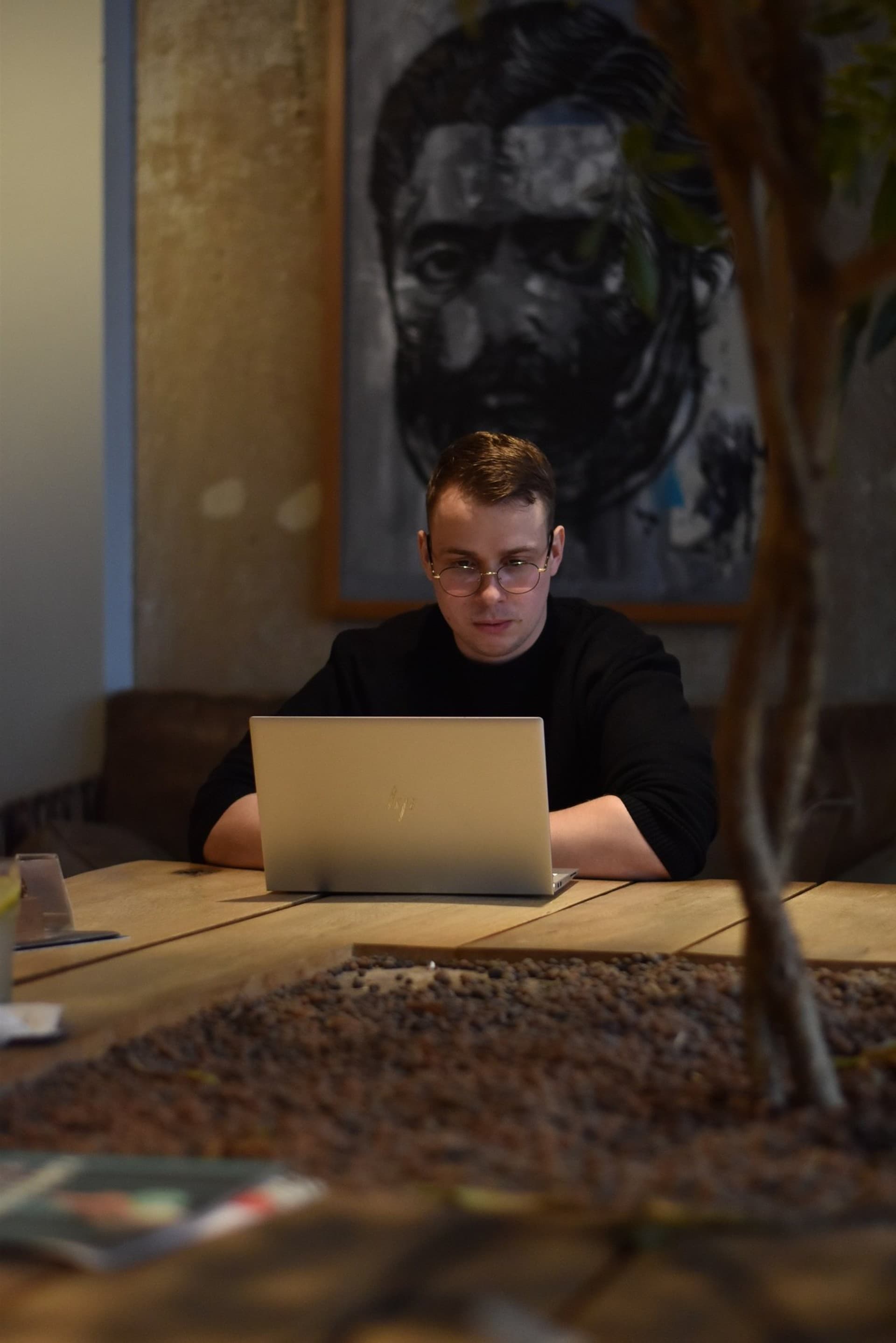 Christopher Krassnig at an outdoor table with a silver laptop